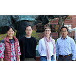 4 members of the Uchida lab standing outside the Harvard biolabs building