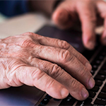 close up of hands on a computer keyboard