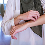 a person scratching their arm