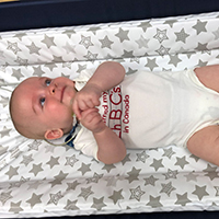 a baby lying in a crib