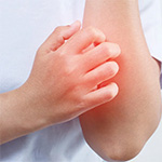 a close up of a person scratching their arm