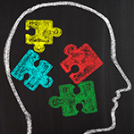 outline of a human head with colorful puzzle pieces inside