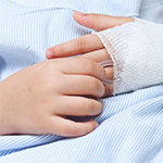close up of a child's hands wearing a cast