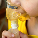 a person breathing through a mask