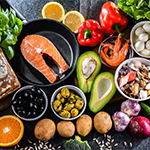 a spread of fruits, vegetables, and fish indicative of the Mediterranean diet