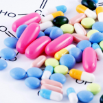 a variety of pills on a background with molecular diagrams