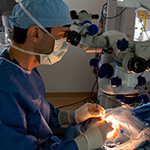 Jason Comander of Mass Eye and Ear performs a surgical procedure to deliver the CRISPR medicine EDIT-101 into the cells of a patient's retina. Image: Mass Eye and Ear