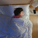 a woman sleeping in a bed
