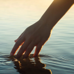 a hand reaching into water