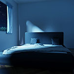 an empty bed in a dark room