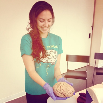 alex holding a brain during a workshop the lab put on for local high schoolers.
