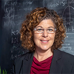 photo of marisa silveri standing in front of a blackboard